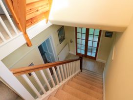 A staircase with a handrail and doors at Glen Avon Seahouses