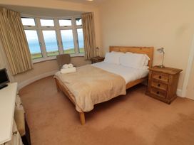 A bedroom with a bed and bedside tables at Glen Avon in Seahouses