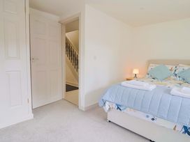 A bedroom with a bed and staircase at The Cottage Middle Westwater in Westwater Nr Axminster