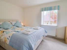 A bedroom with a bed and window at The Cottage Middle Westwater