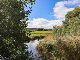 A view of a stream surrounded by greenery and fields at The Cottage Middle Westwater Westwater Nr Axminster