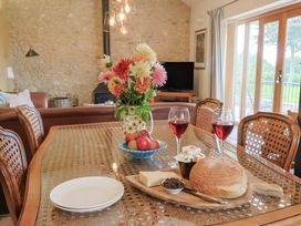 A dining room with a table set for a meal at The Sundowner in Wyke Nr. Axminster