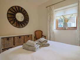 A bedroom with towels on a bed at The Sundowner in Wyke Nr. Axminster