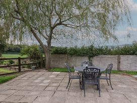 An outdoor patio area with a table and chairs at The Sundowner, Wyke Nr. Axminster