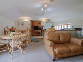 A kitchen with a dining area and couch at The Granary in Wyke Nr Axminster