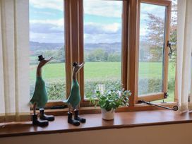 A living room with a window and duck figurines at The Granary in Wyke Nr Axminster