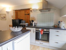 A kitchen with appliances and utensils at The Granary Wyke Nr Axminster