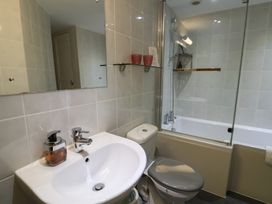 A bathroom with a sink, toilet, and bathtub at The Granary in Wyke Nr Axminster