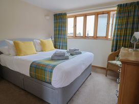 A bedroom with a bed and towels on The Granary in Wyke Nr Axminster