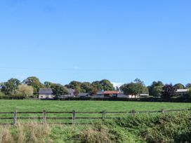 A field with trees and houses in the background at The Granary Wyke Nr Axminster