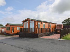 A mobile home with decking at Cody Cottage Lodge Mullacott Park near Ilfracombe