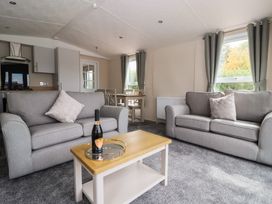 A living room with sofas and a dining table at Meadows Park 1 Great Hatfield near Hornsea