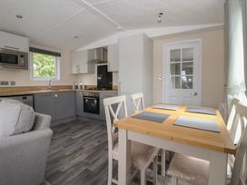 A kitchen with appliances and dining table at Meadows Park 1 Great Hatfield near Hornsea