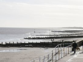 A beach scene with a walkway and groynes at Great Hatfield near Hornsea
