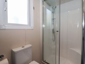 A bathroom with a shower and toilet at Meadows Park 1 Great Hatfield near Hornsea