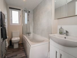 A bathroom with a tub, shower, sink, and toilet at Meadows Park 1 Great Hatfield near Hornsea
