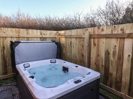 A hot tub surrounded by a wooden fence at Meadows Park 1, Great Hatfield near Hornsea