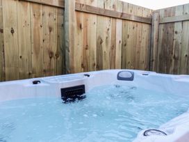 A hot tub surrounded by a wooden fence at Meadows Park 1 Great Hatfield near Hornsea