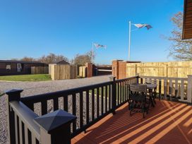 An outdoor deck with table and chairs at Meadows Park 1 Great Hatfield near Hornsea