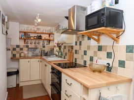 A kitchen with cabinets and appliances at Cosy Nook in South Molton