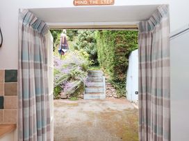 A doorway leading to steps and garden plants at Cosy Nook in South Molton