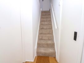 A hallway with stairs and a door at Cae Gwyn in Ty Croes
