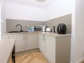 A kitchen with appliances including a microwave and toaster at Cae Gwyn in Ty Croes