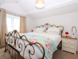 A bedroom with a bed and bedside table at Cae Gwyn in Ty Croes