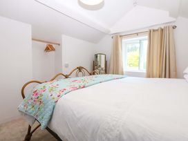 A bedroom with a bed and a window at Cae Gwyn in Ty Croes