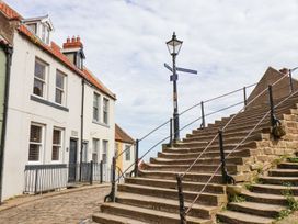 A staircase and houses in a street at Greenfingers in Whitby