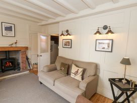 A living room with a sofa and fireplace at Greenfingers in Whitby