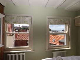 A bedroom with windows showing a view at Greenfingers in Whitby