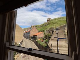 A view of a street and stairs from a window at Greenfingers in Whitby