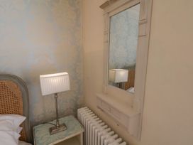 A bedroom with a bed and a lamp at Greenfingers in Whitby