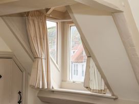 An attic with a window and curtains at Greenfingers in Whitby