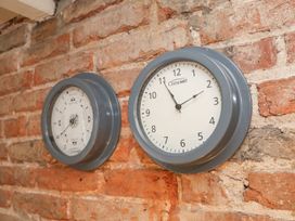 Two clocks on a brick wall at Greenfingers Whitby