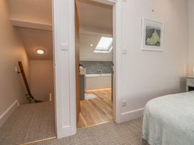 A bedroom with a staircase and an open doorway to a bathroom at Wansfell Nook in Ambleside