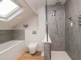 A bathroom with a bathtub, toilet, and shower at Wansfell Nook in Ambleside