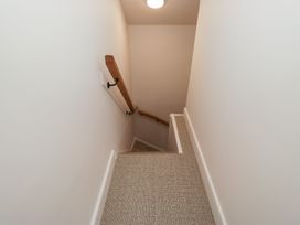 A staircase with a handrail at Wansfell Nook in Ambleside