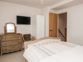 A bedroom with a bed, dresser, and television at Wansfell Nook in Ambleside