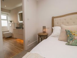 A bedroom with a bed and a bathroom visible at Wansfell Nook in Ambleside