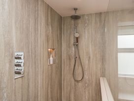 A shower with controls and a soap dispenser at Wansfell Nook in Ambleside