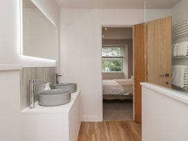 A bathroom with sinks and a wooden door at Wansfell Nook in Ambleside