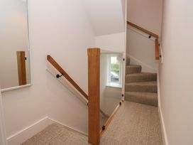 A staircase with a handrail and mirror at Wansfell Nook in Ambleside