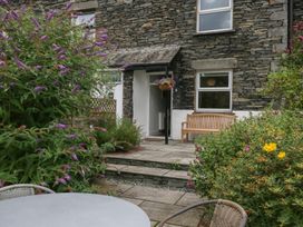 An outdoor area with flowers and seating at Wansfell Nook in Ambleside