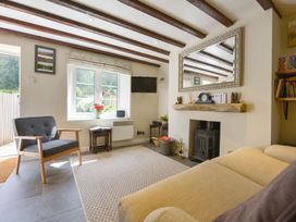 A living room with a sofa and armchair at Woodedge in Minehead