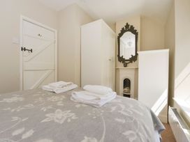 A bedroom with a bed and towels at Woodedge in Minehead