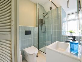 A bathroom with a toilet shower and sink at Woodedge in Minehead