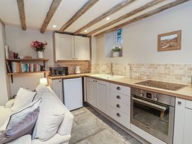 A kitchen with storage, appliances and a worktop at Woodedge in Porlock