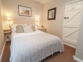 A bedroom with a bed and bedside table at Woodedge in Porlock